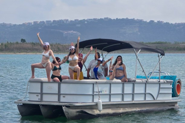 a group of people in a boat on a body of water