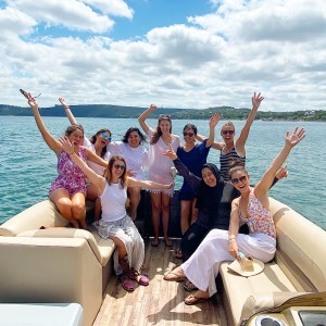 a group of people on a boat posing for the camera
