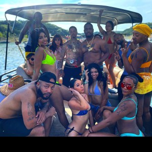a group of people on a boat posing for the camera