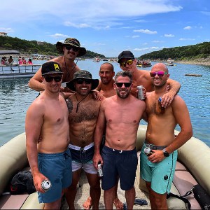 a group of people standing next to a body of water