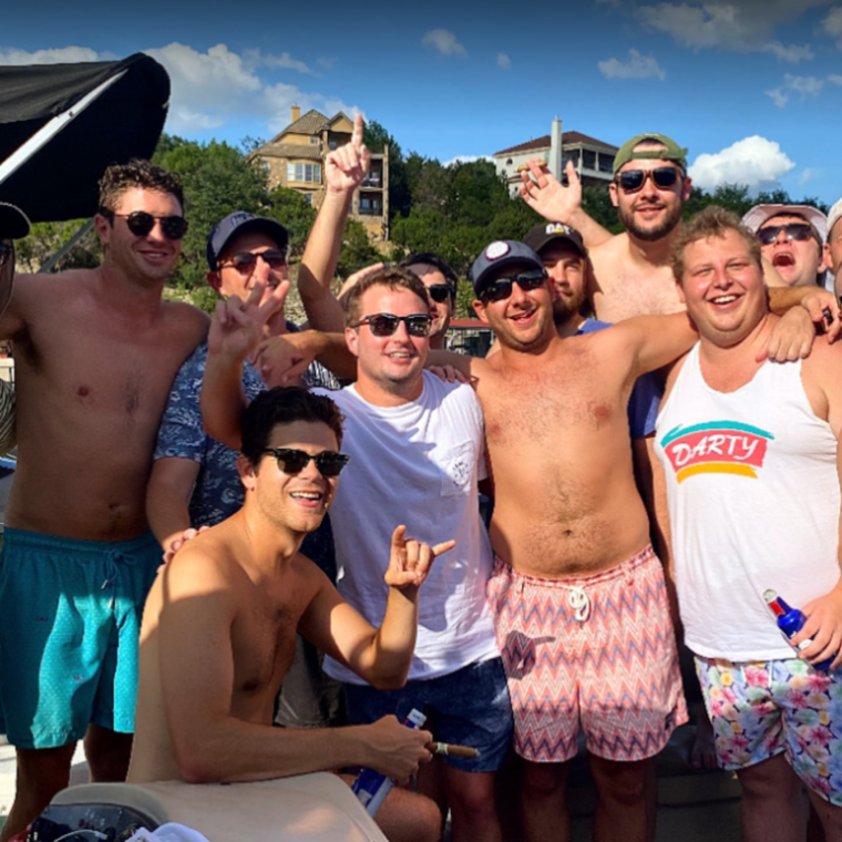 Tony Dize et al. standing in front of a crowd posing for the camera