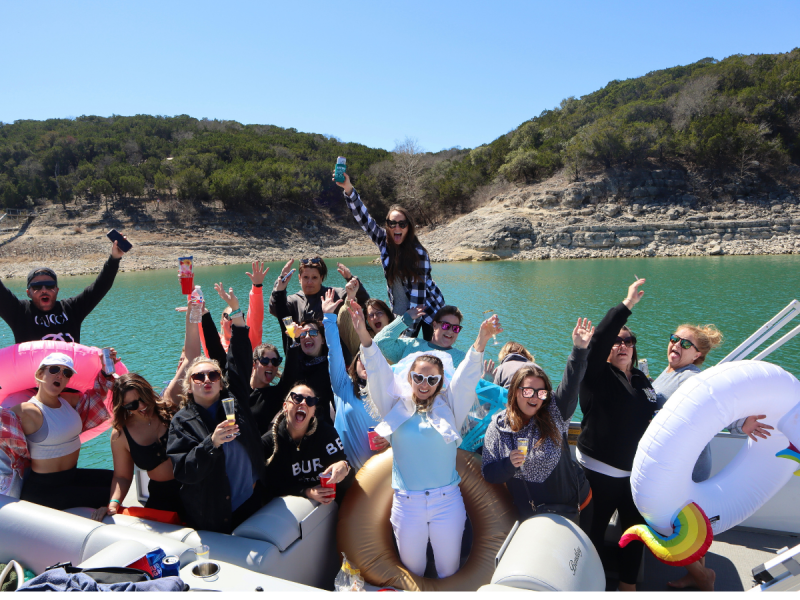 a group of people on a beach posing for the camera