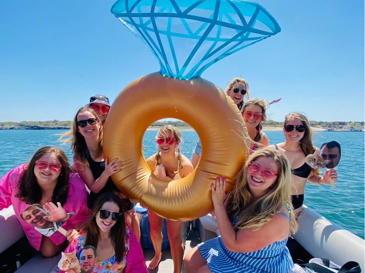 a woman standing next to a body of water posing for the camera