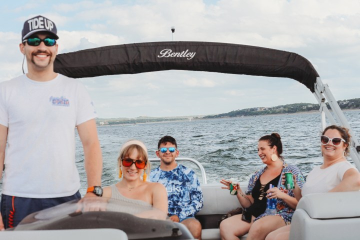 a group of people on a boat posing for the camera