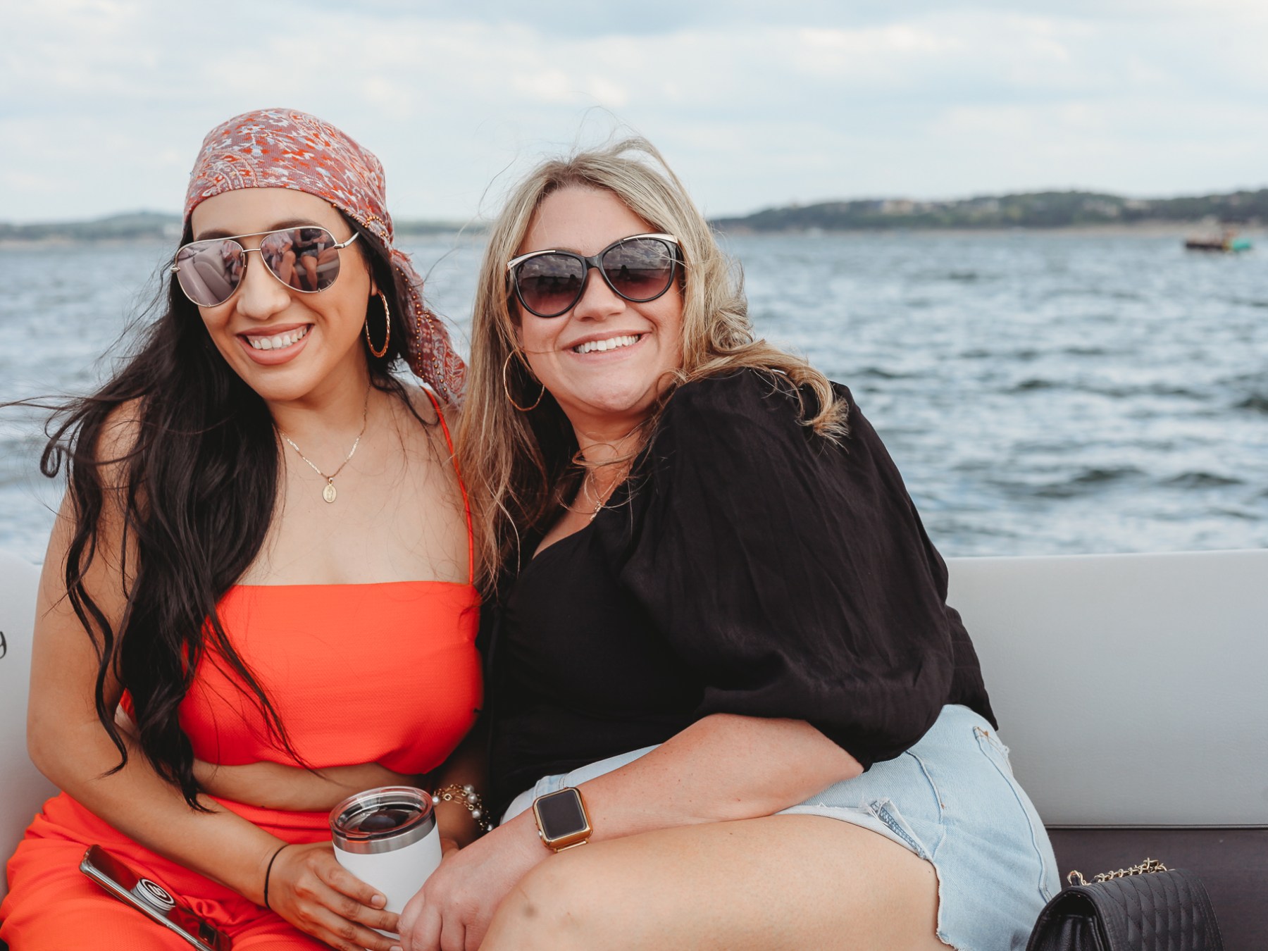 a woman standing next to a body of water