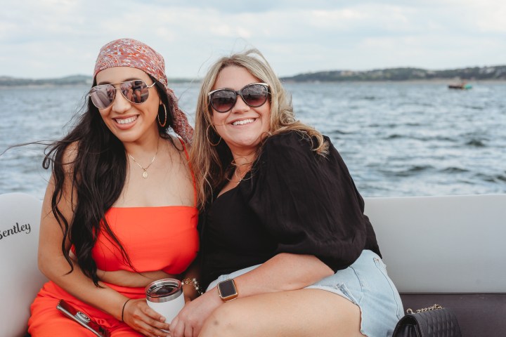 a woman standing next to a body of water