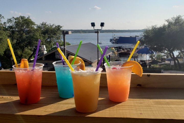 a glass of orange juice next to a picnic table