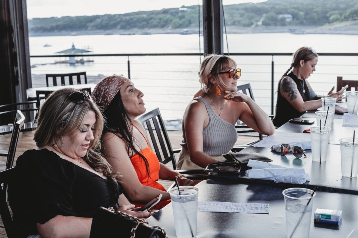 Kelly Clarkson et al. that are sitting on a boat in the water