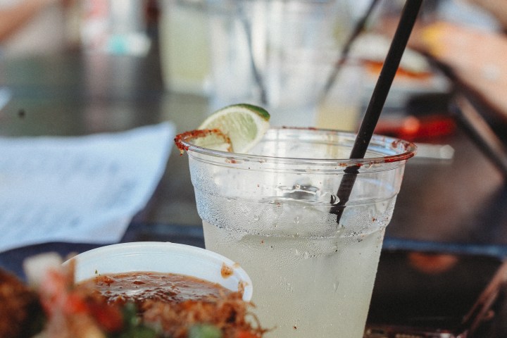 a plate of food with a slice of pizza on a table