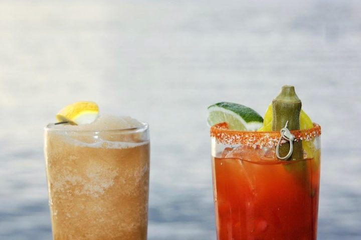 a glass of orange juice next to a cup of coffee