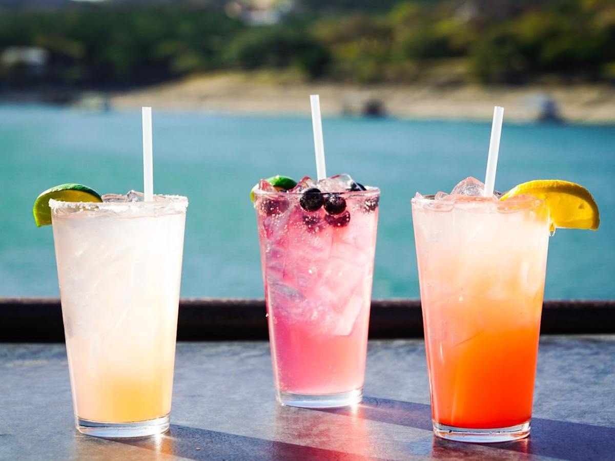 a glass of orange juice next to a cup of water