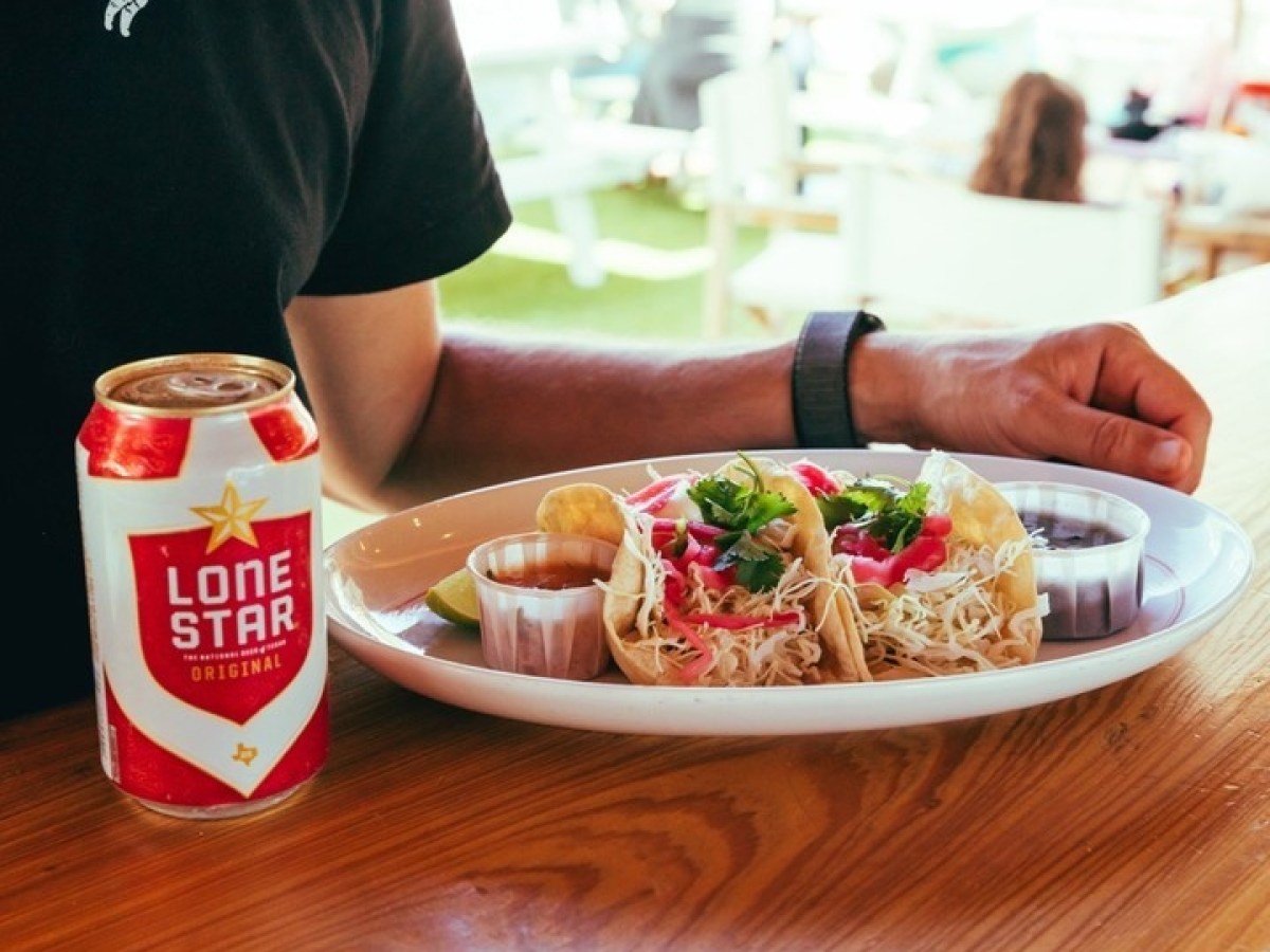a person sitting at a table with a plate of food