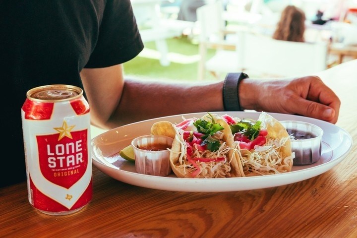 a person sitting at a table with a plate of food