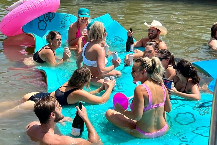 a group of people swimming in a pool of water