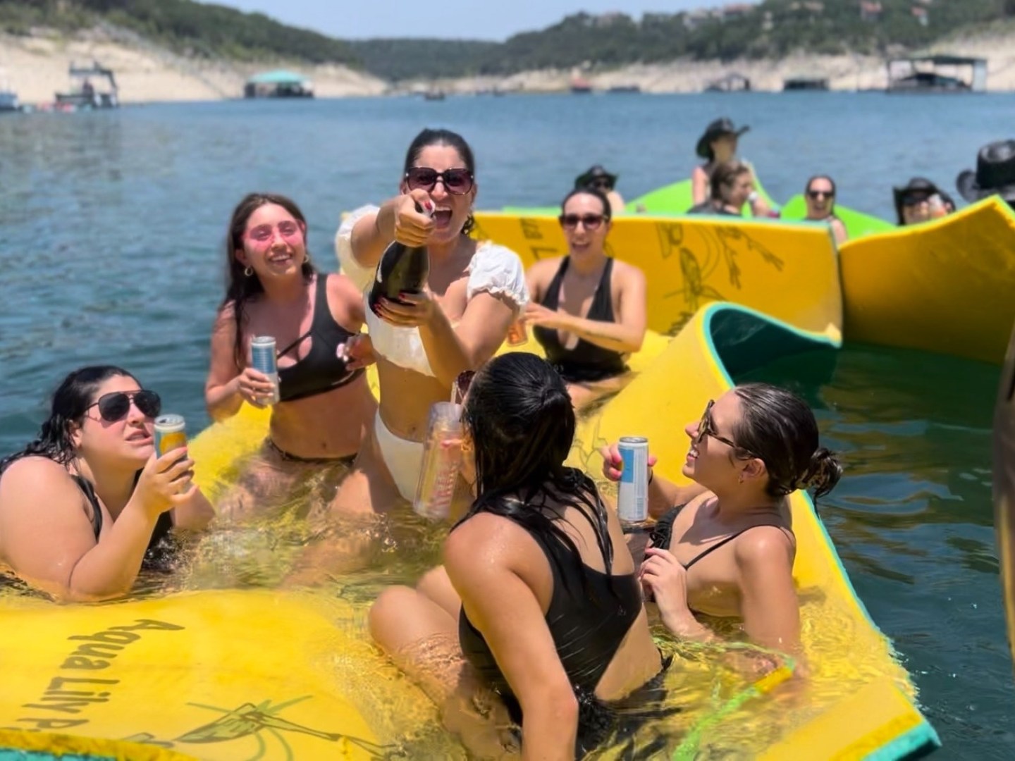 a group of people sitting on a raft in a body of water