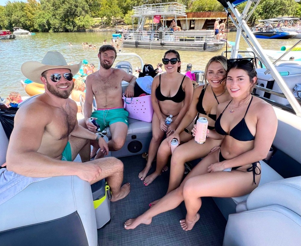 a group of people sitting on a boat posing for the camera