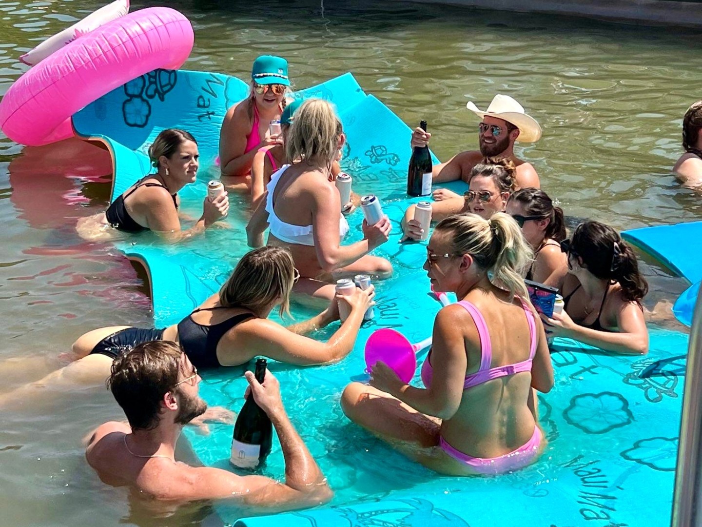 a group of people swimming in a pool of water
